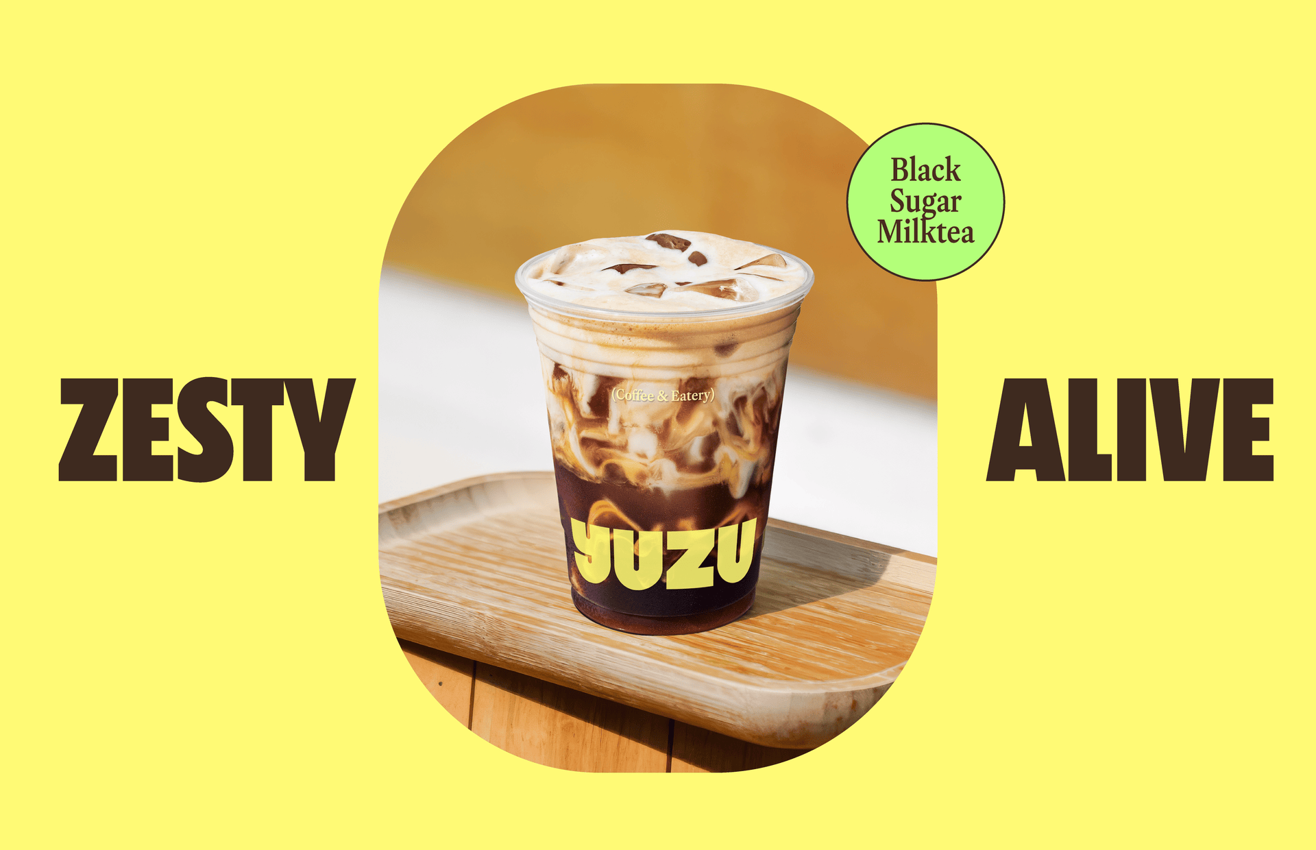 Yuzu Cafe iced black sugar milk tea on a wooden tray